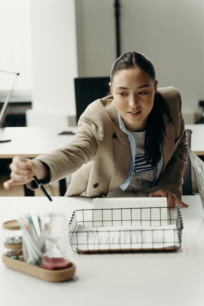 Services Asian businesswoman planning a project in a modern workplace environment.